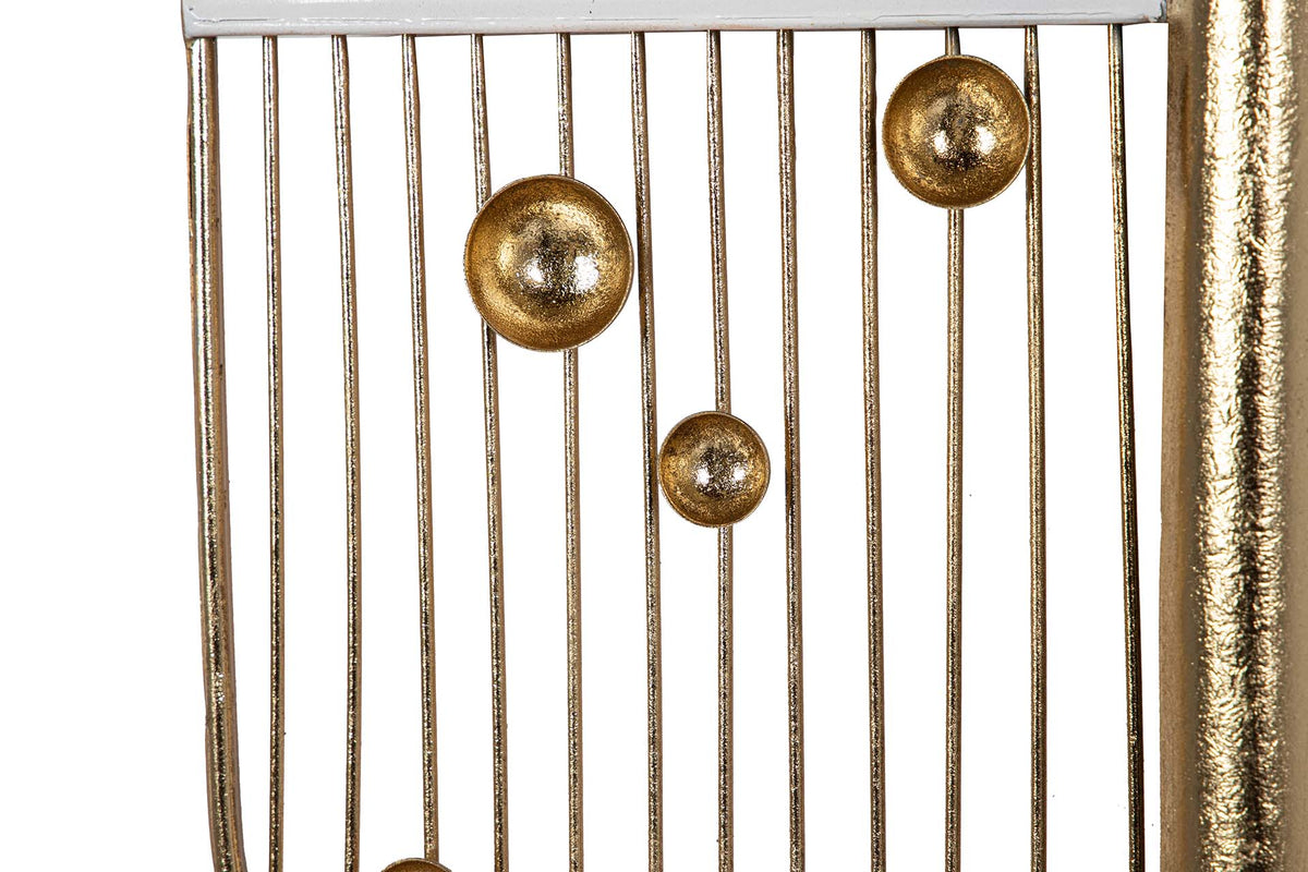 Close-up of a gold-toned metal chair or stool with vertical slats and three round metallic finials | KULORI Malta & Gozo