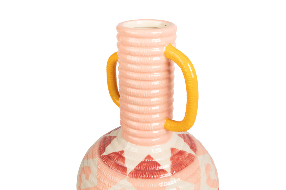 A close-up of a ceramic vase with a ribbed pink neck, two bright yellow handles, and a patterned base in pink, white, and red, shown against a plain white background | KULORI Malta & Gozo