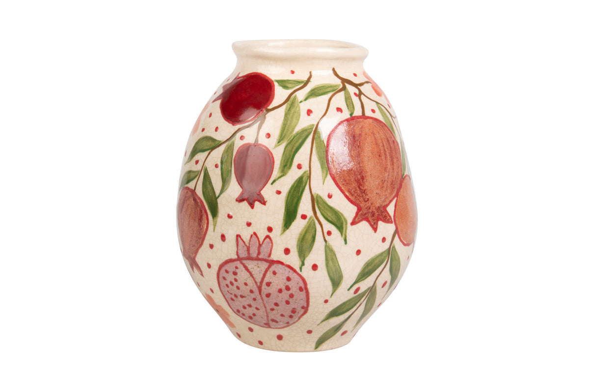 A small ceramic vase with a cream-colored glaze, decorated with hand-painted pomegranate motifs in red and pink, green leaves, and small red dots | KULORI Malta & Gozo