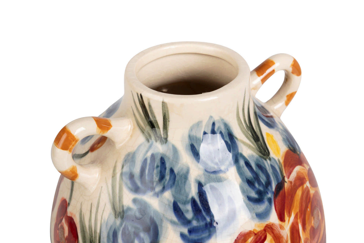 Close-up of a ceramic vase with a cream-colored glaze, hand-painted blue tulips, orange and red floral accents, and two side handles