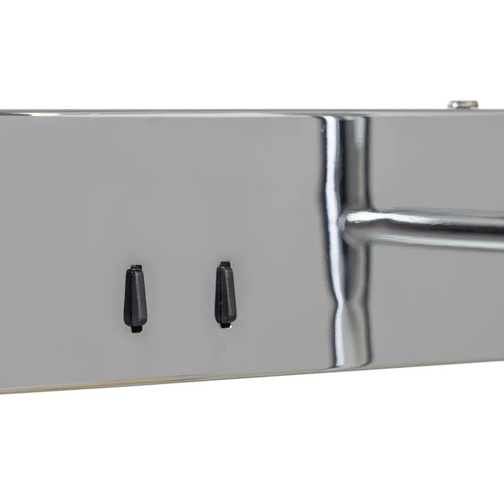 Close-up of a polished iron metal bar or trim with two switches wall lamp