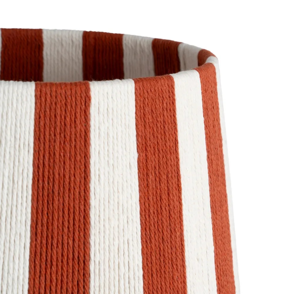 Close-up of a paper rope cylindrical basket or planter with vertical rust-orange and off-white stripes
