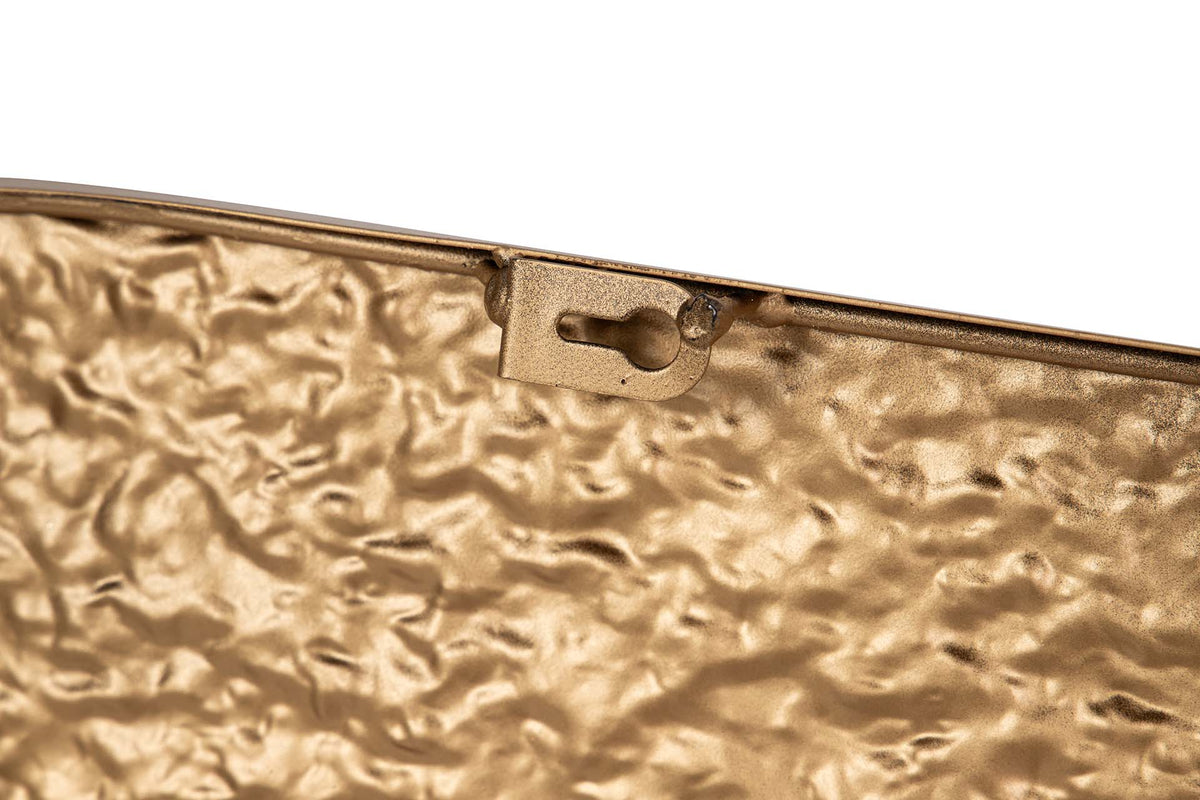Close-up of a textured metallic gold clutch or envelope-style bag corner with a keyhole-shaped metal clasp on a plain white background | KULORI Malta & Gozo