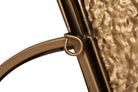 Close-up detail of a bronze metal frame with a textured hammered glass panel and a curved metal rim | KULORI Malta & Gozo