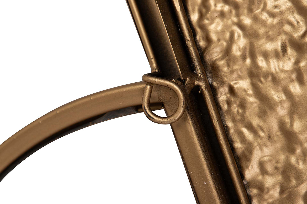Close-up detail of a bronze metal frame with a textured hammered glass panel and a curved metal rim | KULORI Malta & Gozo