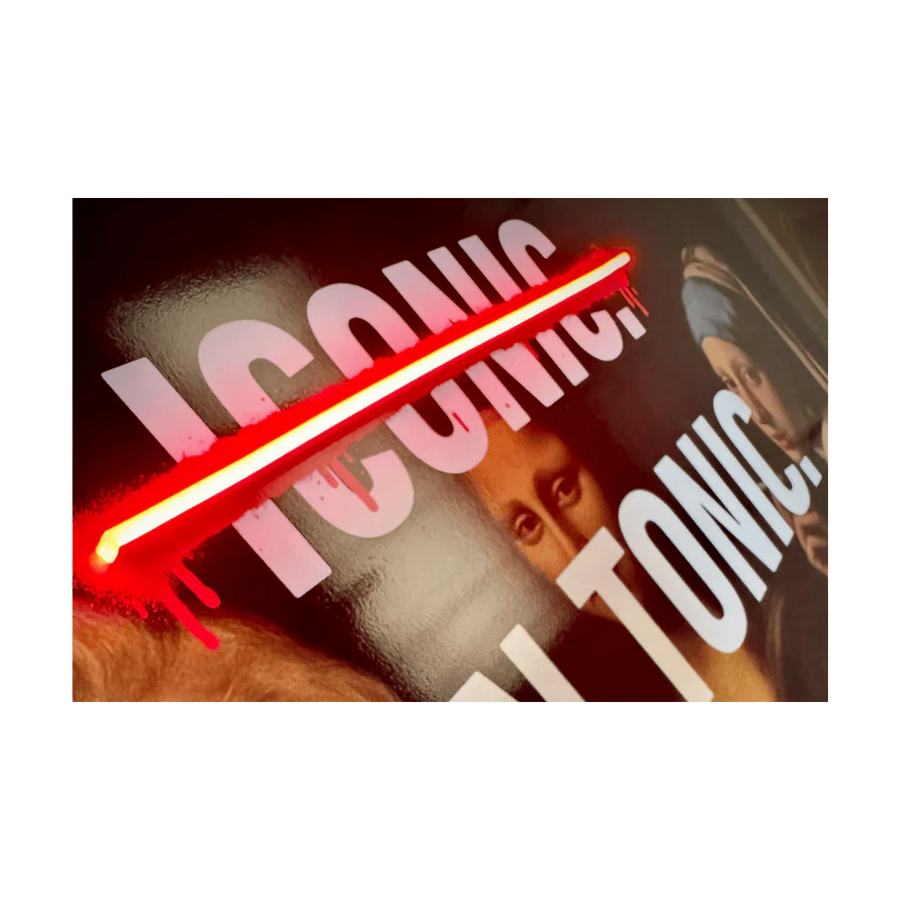 A close-up of a wall sign featuring the word 'ICONIC' in large white letters crossed out by a glowing red neon diagonal bar.