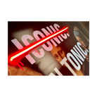 A close-up of a wall sign featuring the word 'ICONIC' in large white letters crossed out by a glowing red neon diagonal bar.