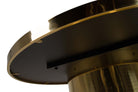 Close-up of a round table base with a brushed gold metal finish and a black circular top surface | KULORI Malta & Gozo