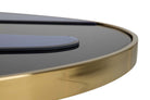 Close-up of a modern round table featuring a glossy black top and a polished gold metal rim | KULORI Malta & Gozo