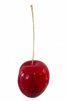 A glossy red cherry with a long, thin stem | KULORI