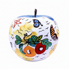 A decorative ceramic apple figurine with a white base, hand-painted with colourful motifs including green leaves | KULORI Malta & Gozo