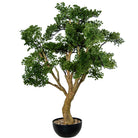 An artificial bonsai-style tree with dense green foliage and a curved brown trunk, planted in a black round pot filled with small pebbles, | KULORI Malta & Gozo