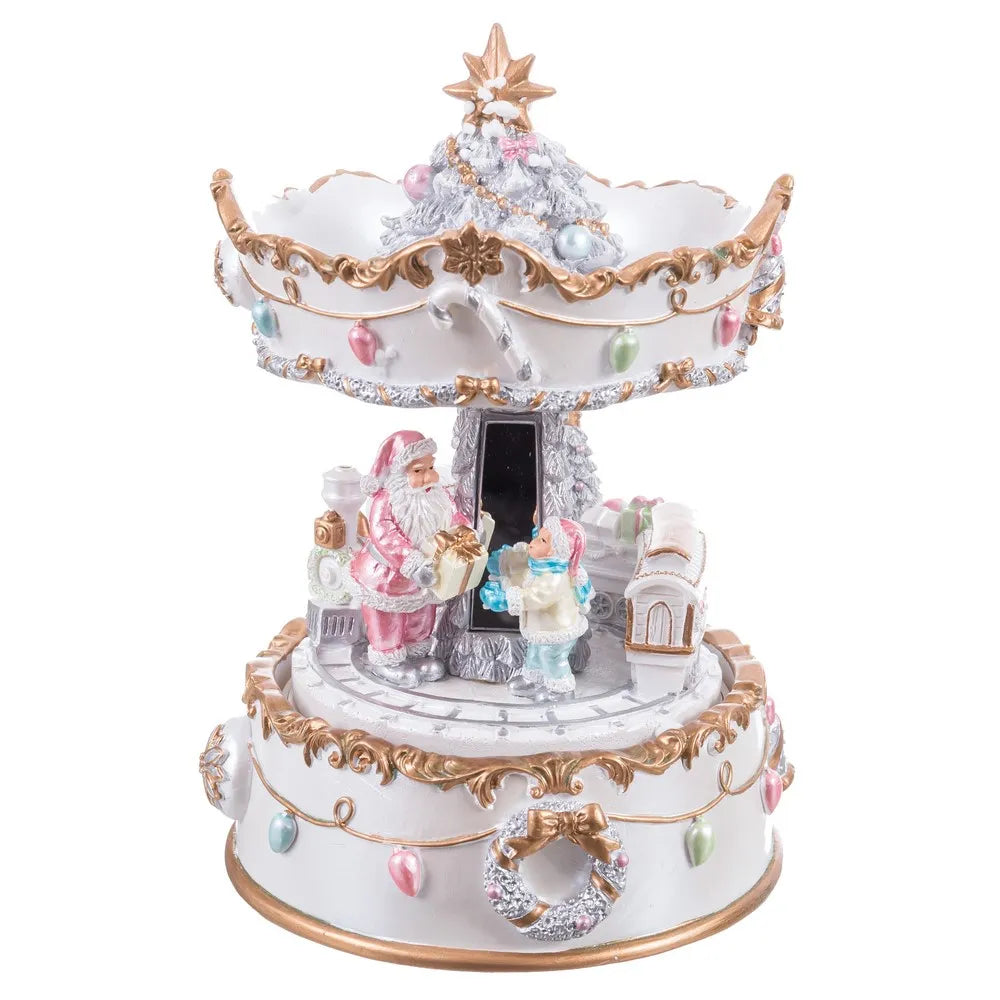 A decorative two-tiered Christmas music box featuring Santa Claus, a snowman, a small Christmas tree, ornaments, wreaths, and gold scrollwork on a white background.