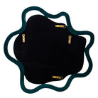 An irregularly shaped wall mirror with a dark teal wavy frame and a black velvet backing, featuring four gold metal mounting brackets | KULORI Malta & Gozo