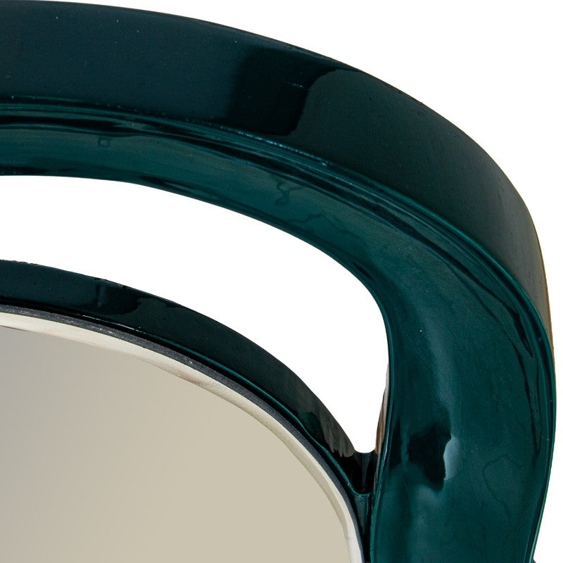Close-up of a glossy dark teal-green curved frame with a reflective silver-toned mirror surface visible at the bottom left | KULORI Malta & Gozo