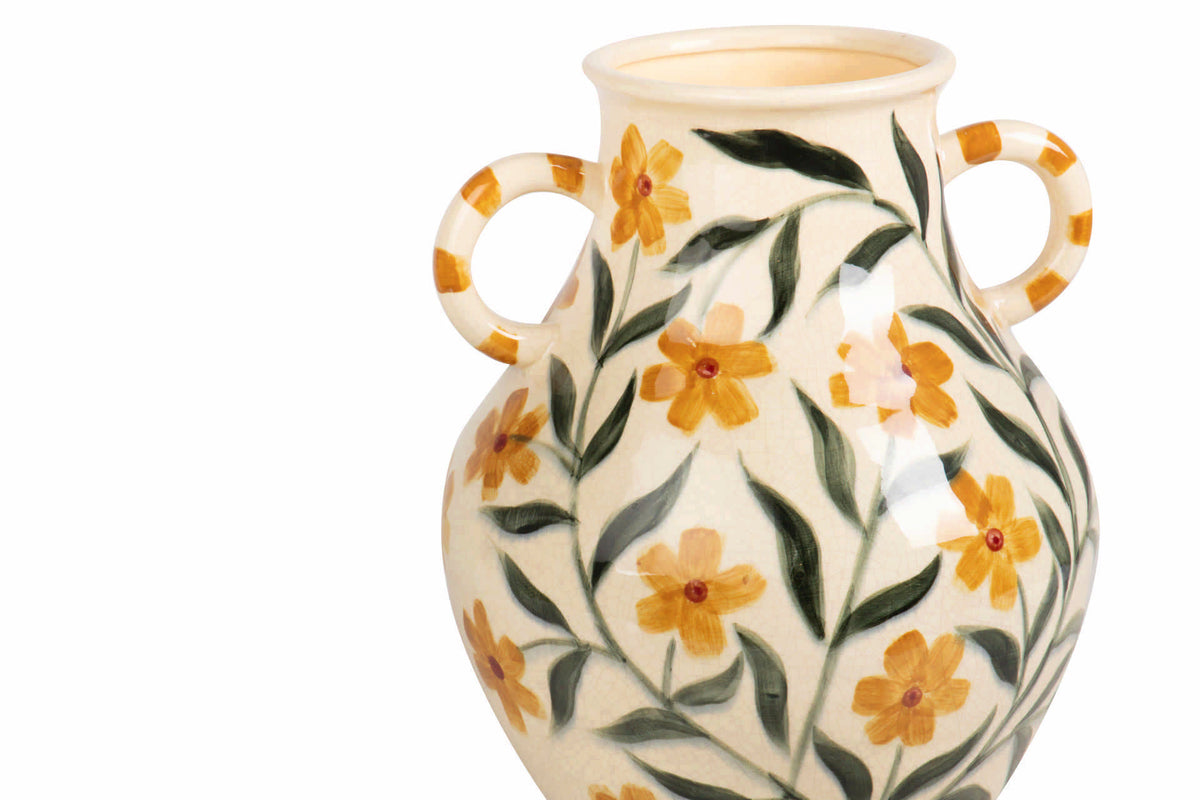 A ceramic vase with two loop handles, decorated with a hand-painted floral pattern of yellow flowers and green leaves.