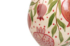Close-up of a ceramic vase decorated with hand-painted pomegranate motifs in red and pink on a cream background with green leaves | KULORI Malta & Gozo