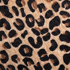 A close-up of leopard print material with irregular black spots | KULORI Malta & Gozo