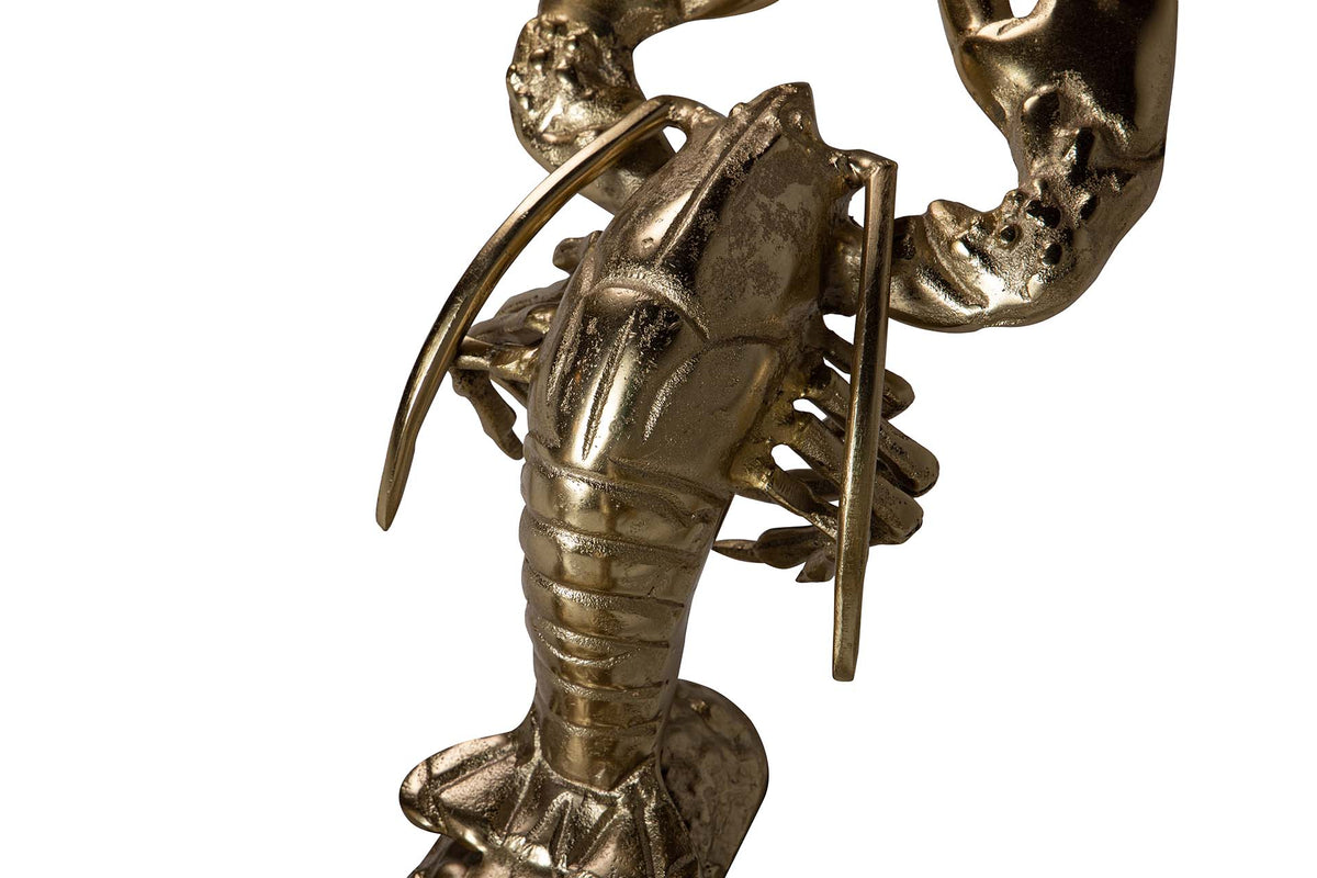 A metallic lobster figurine with a textured, antique gold finish, shown in a close-up detail shot | KULORI Malta & Gozo
