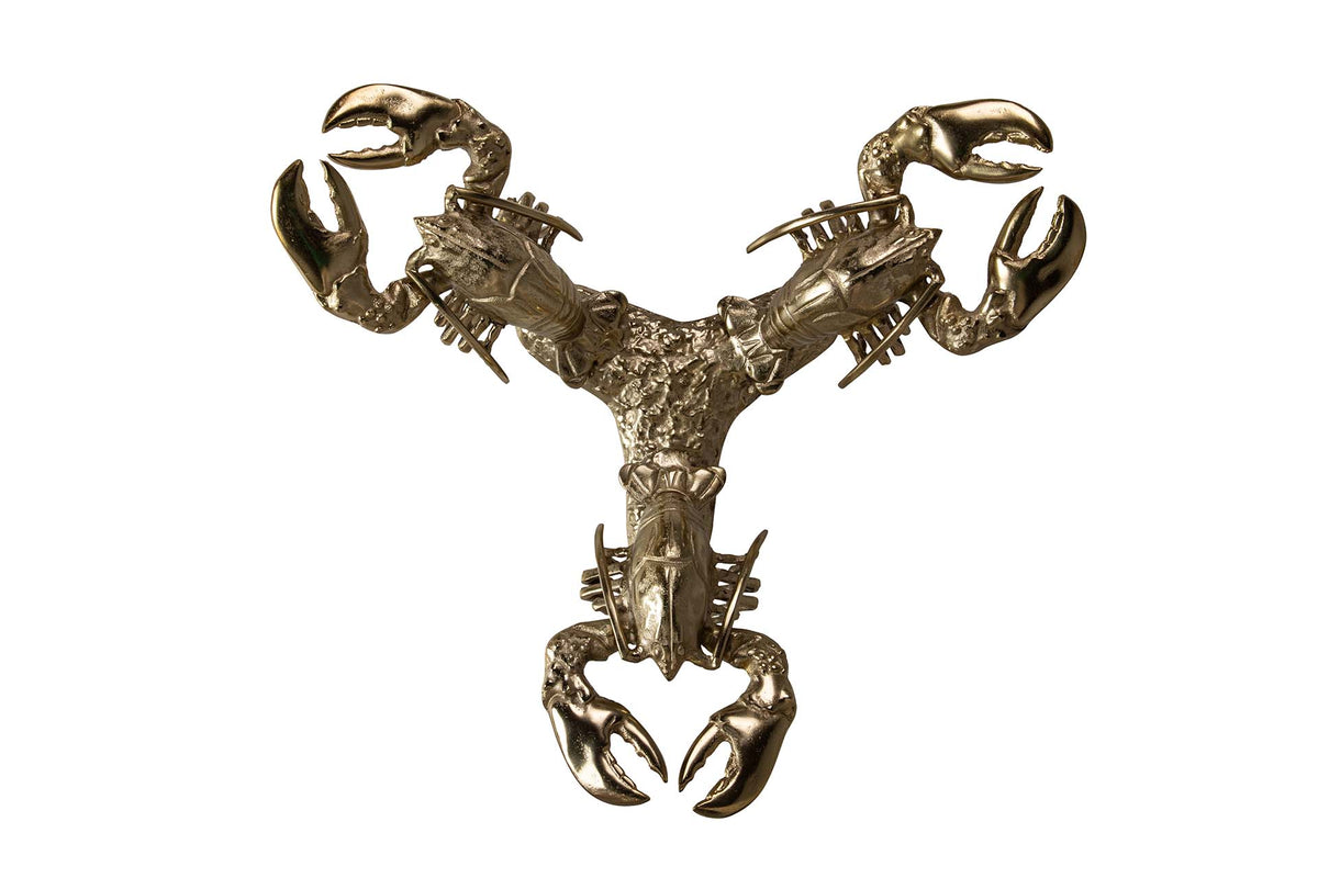 A metallic lobster-shaped wall sculpture or decorative object with a polished gold/bronze finish | KULORI Malta & Gozo