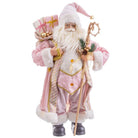 A festive Santa Claus figurine or decoration wearing a pink robe with white fur trim, carrying a sack of gifts and a staff, shown against a plain white background.
