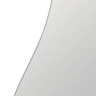 A close-up of a light gray curved surface, likely a mirror or glass panel, with a thin dark edge | KULORI Malta & Gozo
