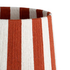 Close-up of a paper rope cylindrical basket or planter with vertical rust-orange and off-white stripes