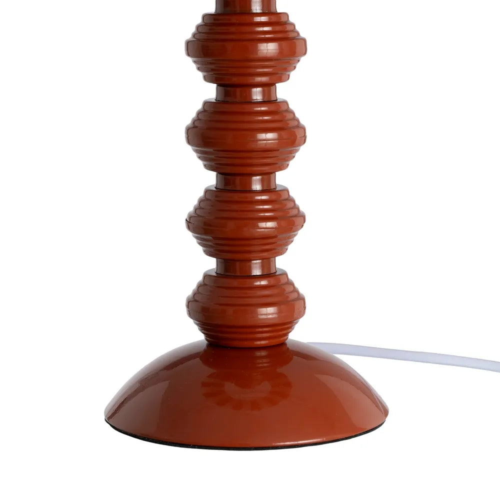 A close-up of a table lamp base with a glossy terracotta brown finish, featuring a flared circular base and a ribbed vertical stem | KULORI